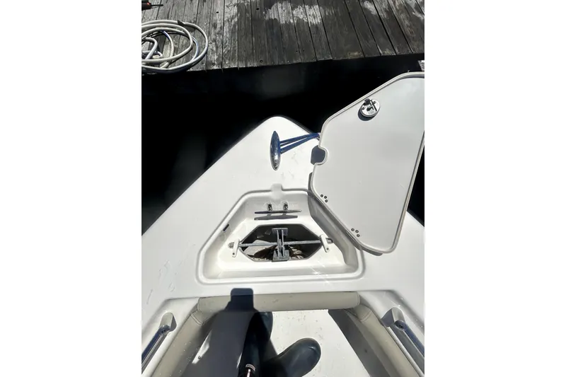 Slide: The Image of 2023 Key West 239 FS boat anchor compartment open at dock. - 22