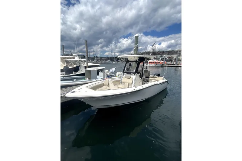 Slide: The Image of 2023 Key West 239 FS boat docked in a marina under cloudy skies. - 24