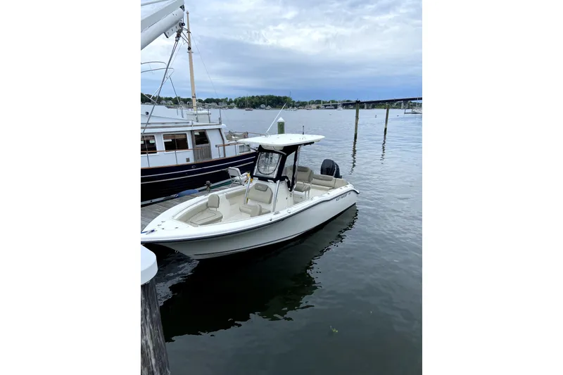 Slide: The Image of 2023 Key West 239 FS boat docked in a serene marina setting. - 26