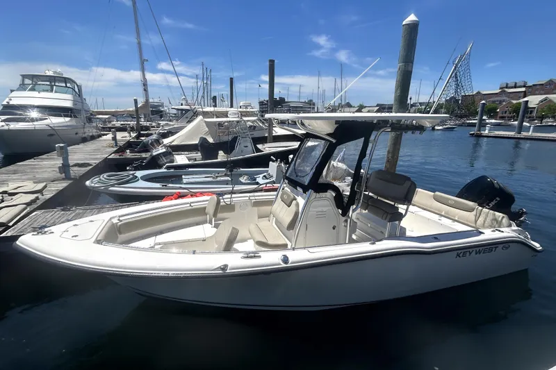 Slide: The Image of 2023 Key West 239 FS boat docked at marina under clear blue sky. - 3