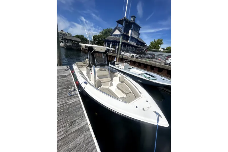 Slide: The Image of 2023 Key West 239 FS boat docked near a waterfront building under a clear blue sky. - 4