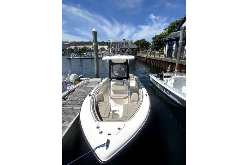 Slide: The Image of 2023 Key West 239 FS boat docked at a marina under a clear blue sky. - 5