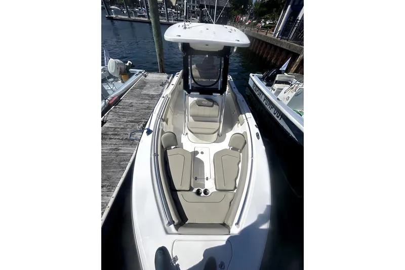 Slide: The Image of 2023 Key West 239 FS boat docked, featuring spacious seating and sleek design. - 6