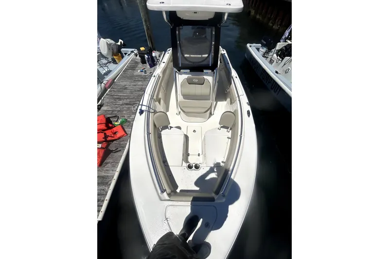 Slide: The Image of 2023 Key West 239 FS boat docked, featuring spacious seating and sleek design. - 9