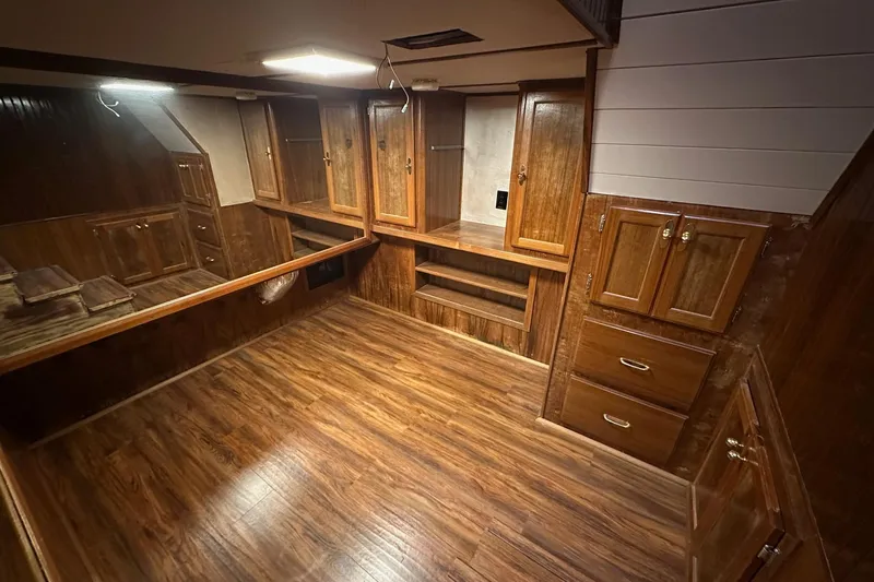 Slide: The Image of Wood-paneled interior of a 1996 Lazy Days 15x64 boat, featuring ample storage cabinets. - 10