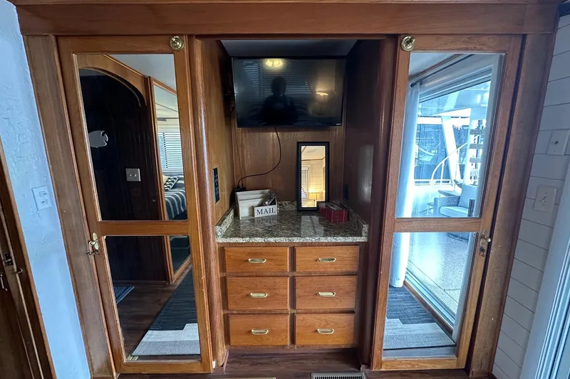 Slide: The Image of Interior of a 1996 Lazy Days 15x64 houseboat with wooden cabinetry and granite countertop. - 13