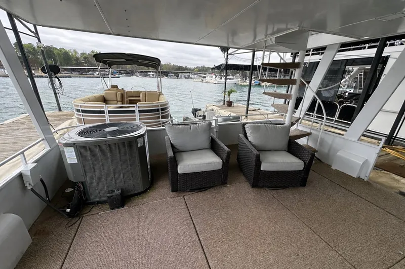 Slide: The Image of Outdoor seating on a 1996 Lazy Days 15x64 houseboat deck by the water. - 18