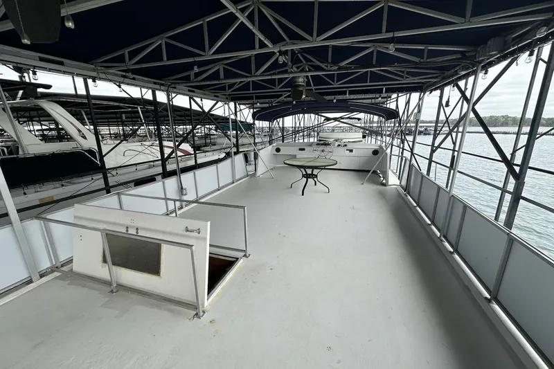 Slide: The Image of Spacious deck of 1996 Lazy Days 15x64 houseboat with table, docked at marina. - 19