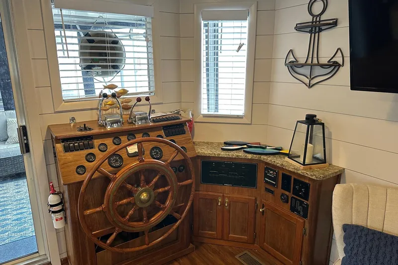 Slide: The Image of Vintage boat helm with wooden wheel, nautical decor, and control panel in a cozy cabin. - 3