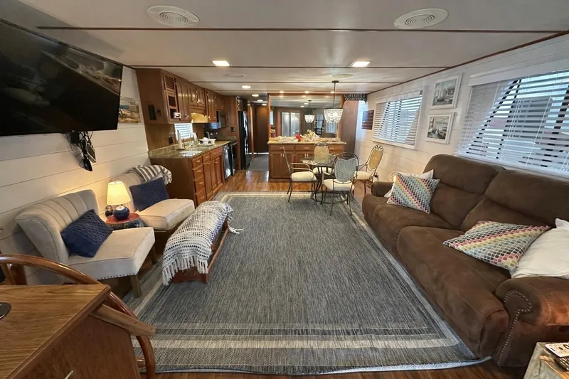 Slide: The Image of Spacious 1996 Lazy Days houseboat interior with cozy seating, dining area, and modern kitchen. - 4