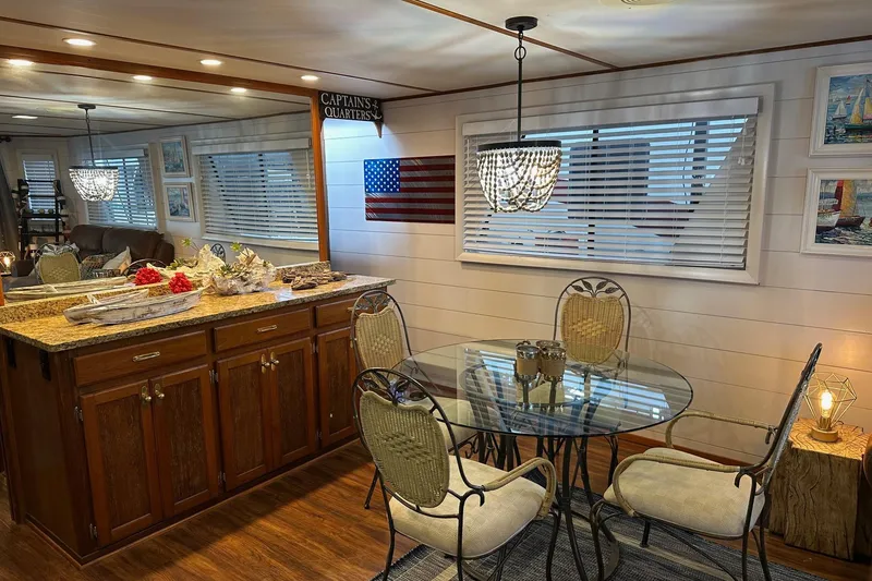 Slide: The Image of Dining area in a 1996 Lazy Days houseboat with elegant decor and wooden cabinetry. - 8