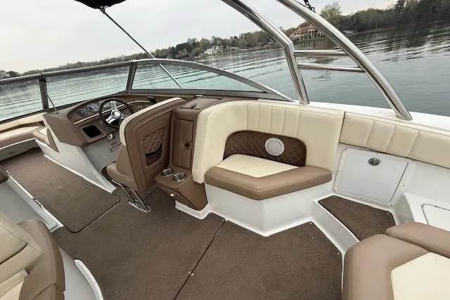 Slide: The Image of Interior of a 2010 Cobalt 276 boat with beige and brown seating. - 12