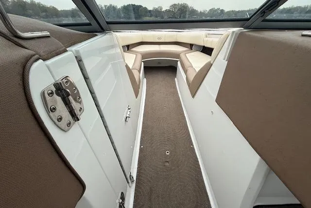Slide: The Image of 2010 Cobalt 276 boat interior with beige seating and carpeted floor. - 18