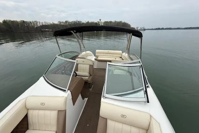 Slide: The Image of 2010 Cobalt 276 boat with beige seating on a calm lake. - 19