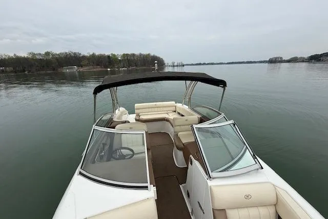 Slide: The Image of 2010 Cobalt 276 boat with open deck, cruising on a calm lake. - 20