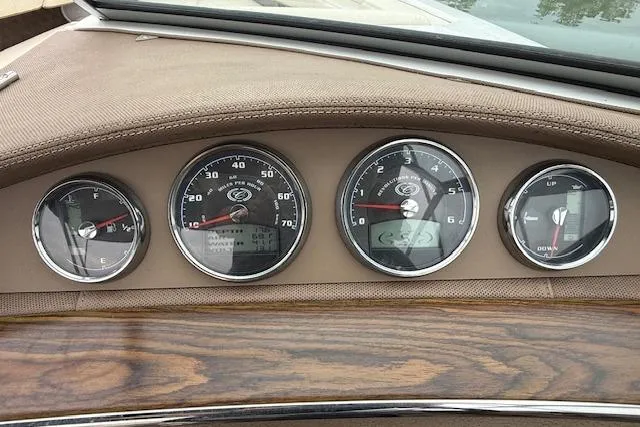 Slide: The Image of Dashboard of a 2010 Cobalt 276 boat with wood trim and analog gauges. - 22