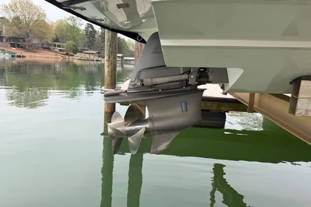 Slide: The Image of 2010 Cobalt 276 boat propeller in calm water near a dock. - 23