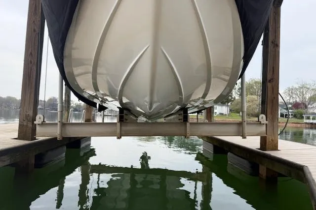 Slide: The Image of 2010 Cobalt 276 boat on lift, docked over calm water. - 5