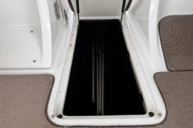 Slide: The Image of Open storage compartment on a 2010 Cobalt 276 boat with carpeted flooring. - 6