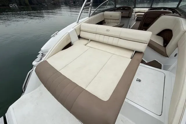 Slide: The Image of 2010 Cobalt 276 boat interior with beige and brown seating on calm water. - 8