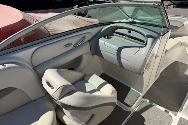 Slide: The Image of Interior of a 2006 Chaparral 220 SSi boat, featuring sleek seating and dashboard. - 11
