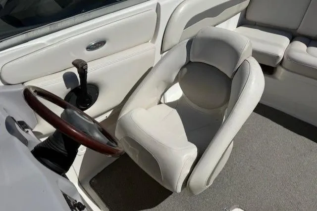 Slide: The Image of 2006 Chaparral 220 SSi boat interior with white seating and steering wheel. - 12