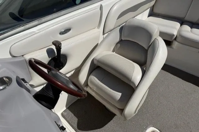 Slide: The Image of 2006 Chaparral 220 SSi boat interior with steering wheel and cushioned seating. - 13