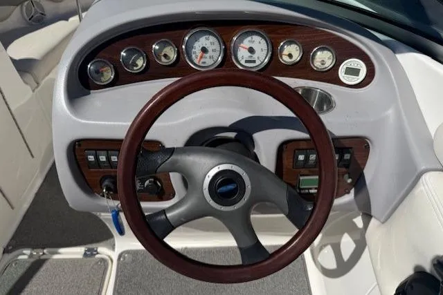 Slide: The Image of 2006 Chaparral 220 SSi boat dashboard with gauges and steering wheel. - 14