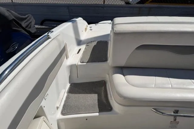 Slide: The Image of Interior view of a 2006 Chaparral 220 SSi boat with white seating and carpeted steps. - 17