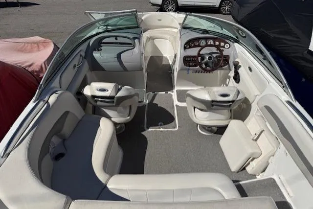 Slide: The Image of 2006 Chaparral 220 SSi boat interior with white seating and modern dashboard. - 20