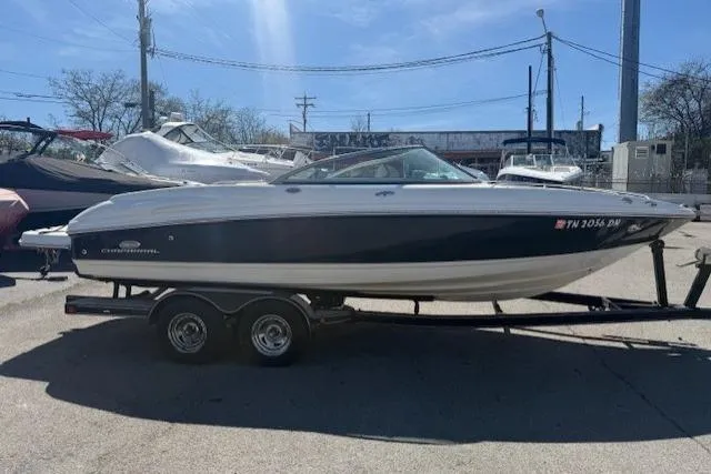 Slide: The Image of 2006 Chaparral 220 SSi boat on trailer, parked outdoors under clear sky. - 4