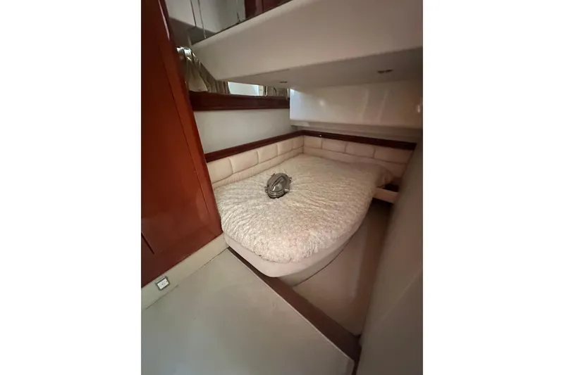 Slide: The Image of Cozy cabin interior of 2002 Fairline 50 yacht with plush bedding and wooden accents. - 10