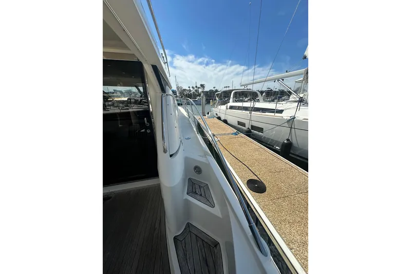 Slide: The Image of 2002 Fairline 50 yacht docked at marina under clear blue sky. - 12