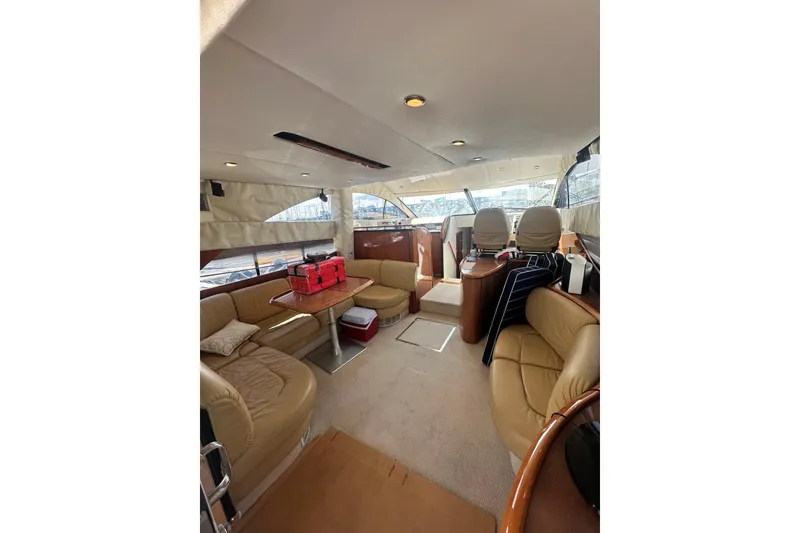 Slide: The Image of Luxurious interior of a 2002 Fairline 50 yacht with leather seating and helm station. - 13