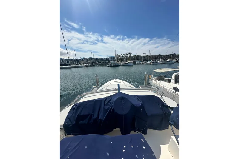 Slide: The Image of 2002 Fairline 50 yacht docked in a sunny marina with clear skies. - 16