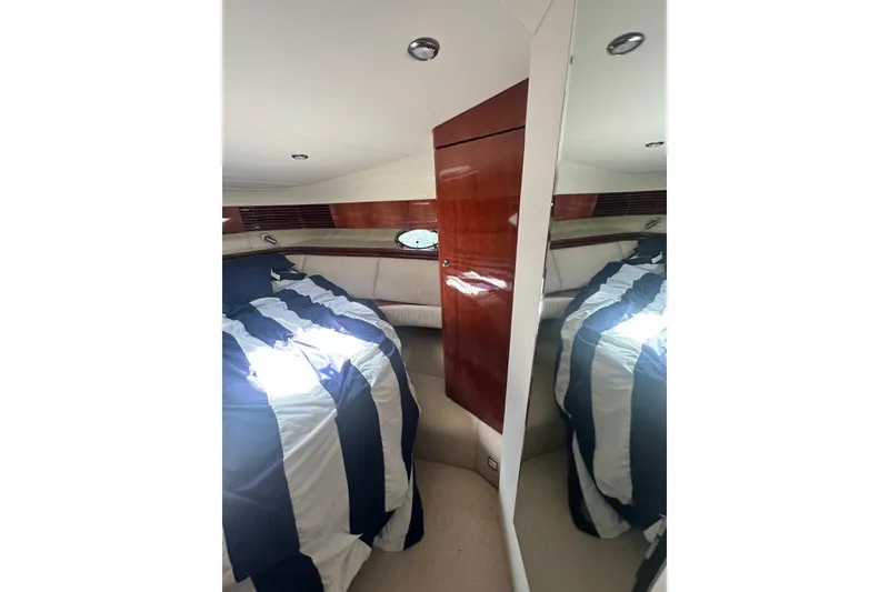Slide: The Image of Interior cabin of 2002 Fairline 50 yacht with striped bedding and wooden accents. - 21