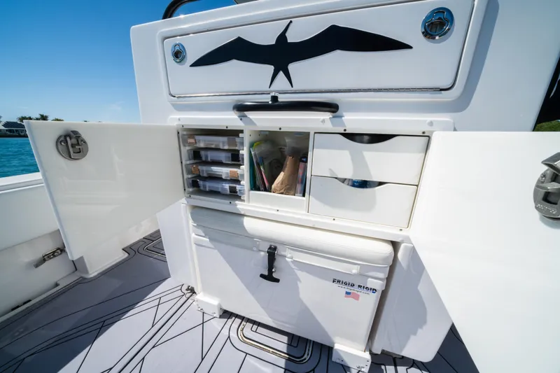 Slide: The Image of Open storage compartment on 2020 Invincible 36 Open Fisherman boat, featuring organized tackle boxes. - 19