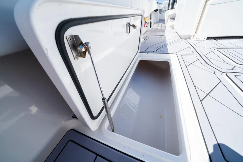 Slide: The Image of Open storage compartment on 2020 Invincible 36 Open Fisherman boat deck. - 20