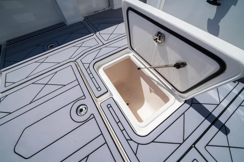 Slide: The Image of Open storage compartment on 2020 Invincible 36 Open Fisherman boat deck. - 22