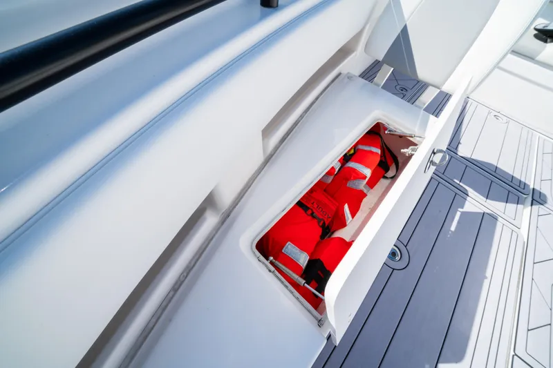 Slide: The Image of Storage compartment with life jackets on a 2020 Invincible 36 Open Fisherman boat. - 9