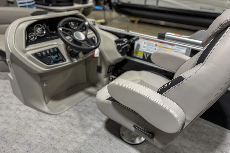 Slide: The Image of Captain's seat and helm of 2025 Trifecta 22UL LE boat, featuring modern controls. - 3