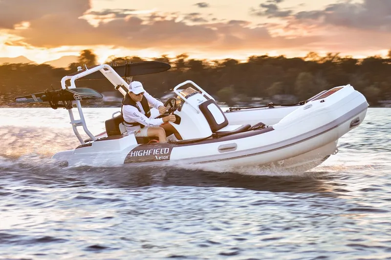Slide: The Image of Manufacturer Provided Image: 2025 Highfield Velox 420 boat cruising on water at sunset. - 2