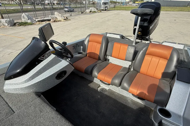 Slide: The Image of 2013 Stratos 176 VLO boat interior with orange and gray seating, steering console, and motor. - 11