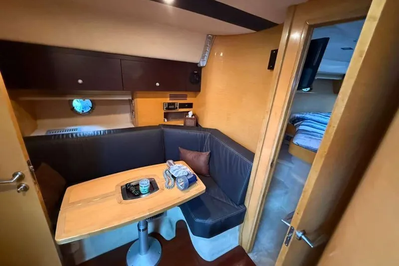 Slide: The Image of Interior of 2009 Cranchi Mediterranee 43 yacht with cozy dining area and cabin view. - 13