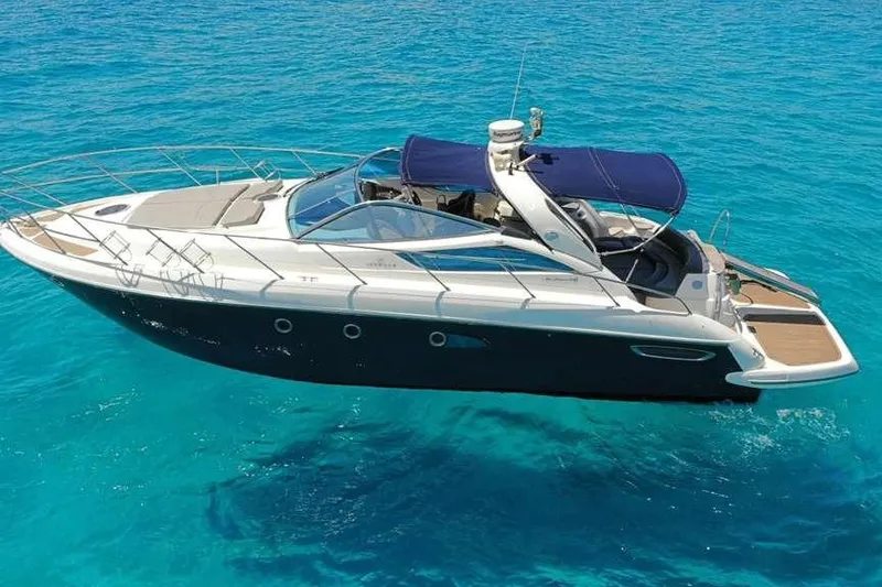 Slide: The Image of 2009 Cranchi Mediterranee 43 yacht on clear blue water, featuring sleek design and sunshade. - 22