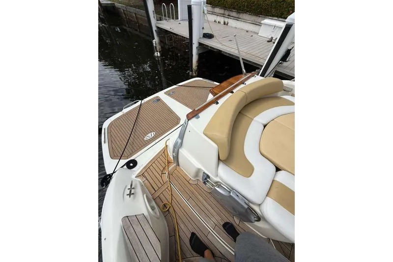 Slide: The Image of 2009 Cranchi Mediterranee 43 yacht with teak deck and beige seating at dock. - 27