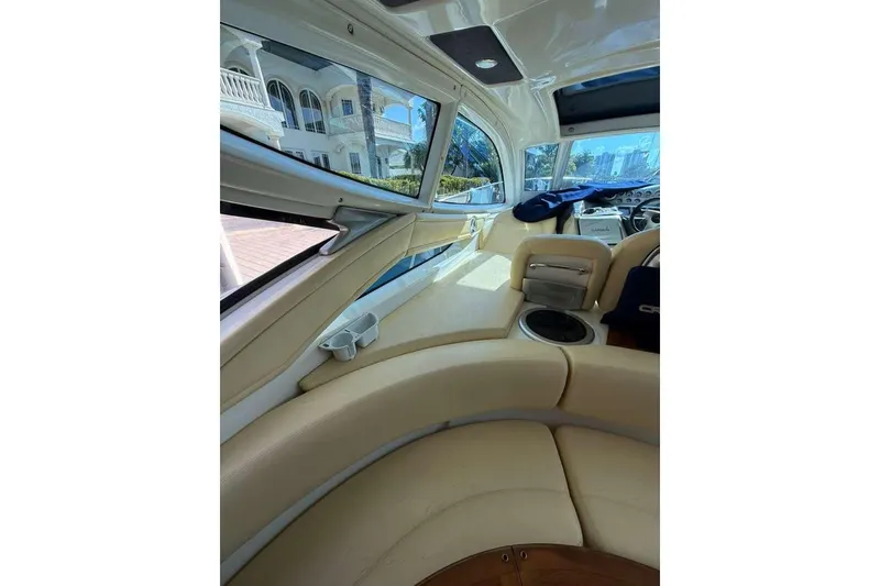 Slide: The Image of Interior of 2009 Cranchi Mediterranee 43 yacht with beige seating and panoramic windows. - 7