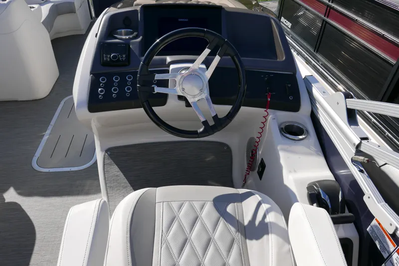 Slide: The Image of Interior view of 2022 Bennington 23 RCW boat cockpit with steering wheel and controls. - 12