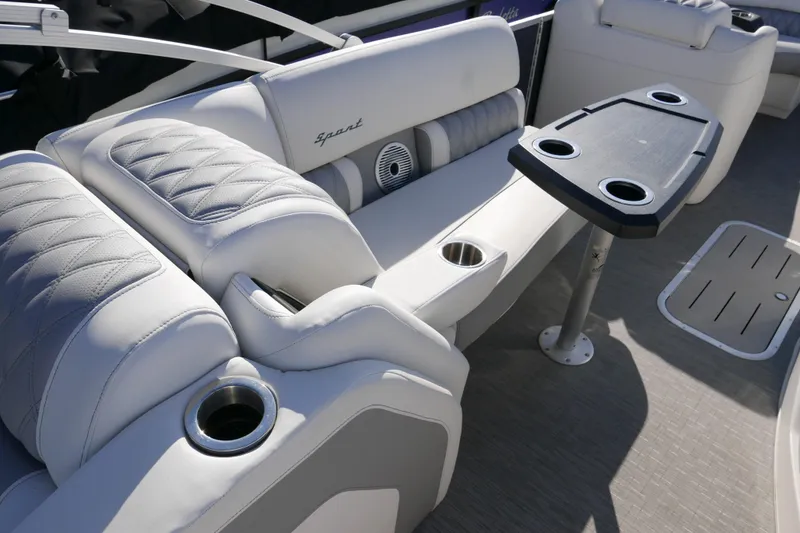 Slide: The Image of Luxurious seating and table setup on a 2022 Bennington 23 RCW pontoon boat. - 13