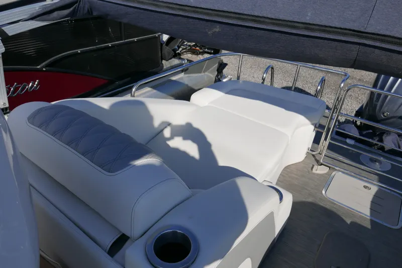Slide: The Image of 2022 Bennington 23 RCW boat interior with luxurious white seating and cup holder. - 15